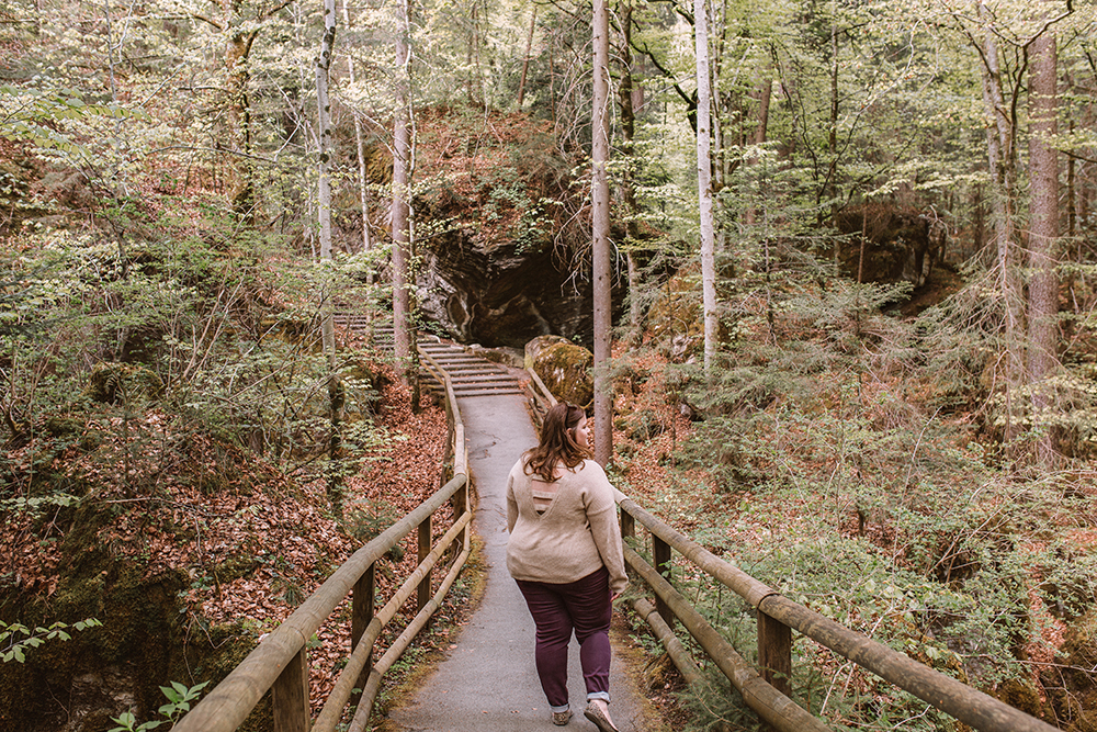 walking through the nature preserve full of rustic pathways and so much greenery at Lake Blausee, Switzerland