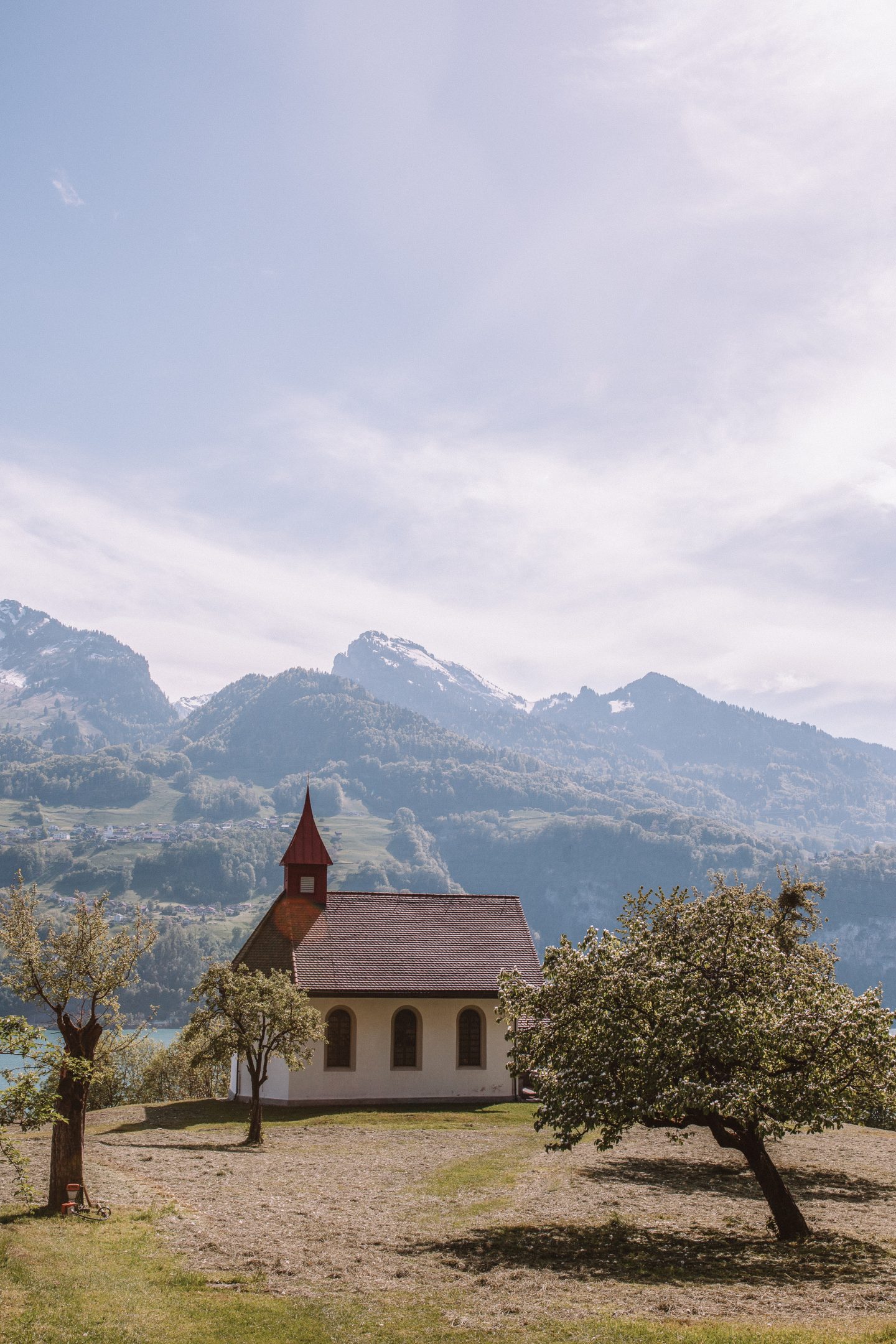 A Swiss church with the Alps in the backgrounds.